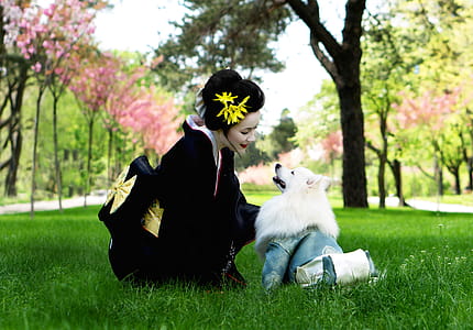 Woman In Black Kimono Looking At White Japanese Spitz thumbnail
