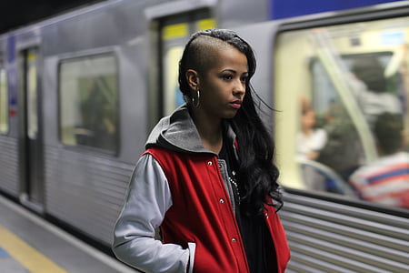 woman standing beside train thumbnail