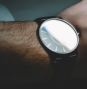 person wearing analog watch thumbnail