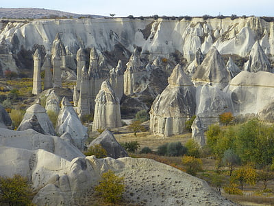 green trees near rock formation thumbnail