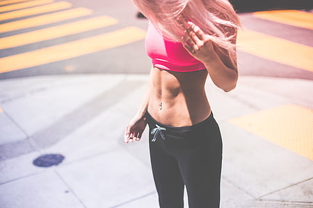 woman in pink sport brassiere and black leggings thumbnail