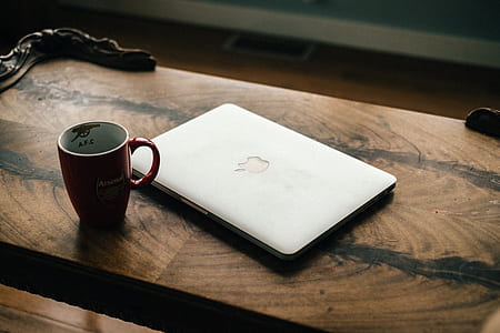 silver MacBook near ceramic mug thumbnail