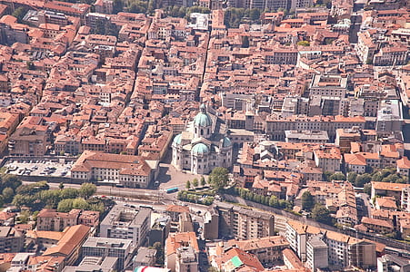 aerial photography of brown concrete buildings with cathedral thumbnail