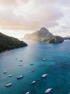 white boats on body of water near islands thumbnail