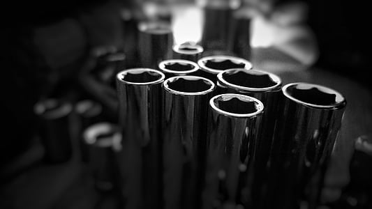 grayscale photography of chrome lug nuts thumbnail