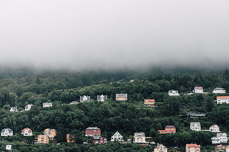 photo of brown and white houses under cloudy sky during daytime thumbnail