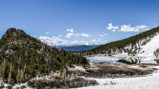 mountain near body of water under blue sky during daytime thumbnail