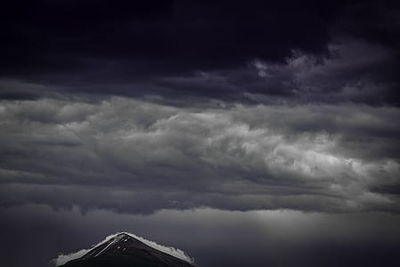 brown mountain under gray clouds thumbnail