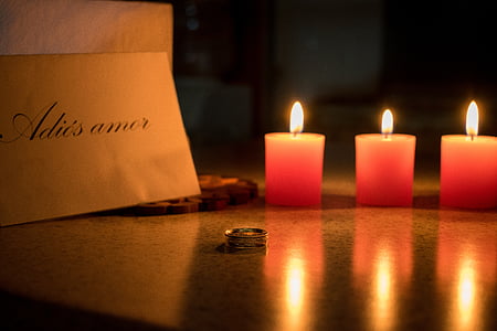 three candles near silver-colored ring thumbnail