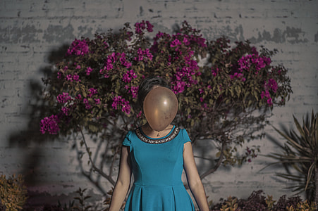 woman standing in front of pink bougainvillea flowers thumbnail