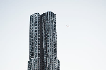 plane near high raise building thumbnail