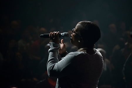 woman singing in front of crowd thumbnail