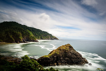 photo of mountain and beach at daytime thumbnail