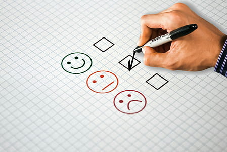 Photo illustration of a person filling out a customer satisfaction survey. thumbnail