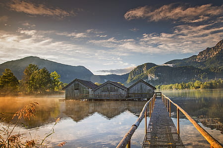 gray wooden houses on body of water thumbnail