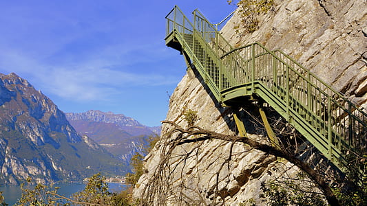 gray metal stair beside rock formation thumbnail