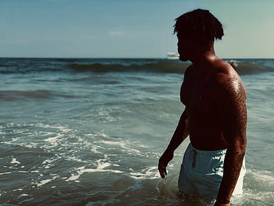 Man Wearing White Boardshorts at Sea thumbnail