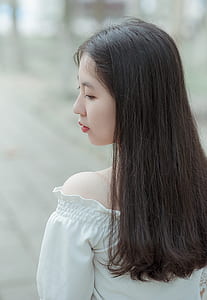 Woman Wearing White Off-shoulder Top thumbnail