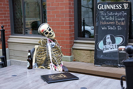 skeleton sitting on chair near menu board on storefront thumbnail