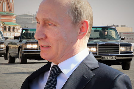 Vladimir Putin standing near vehicles thumbnail