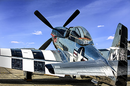 gray biplane under blue sky thumbnail