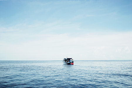 fishing boat on sea during daytime thumbnail