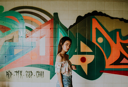 girl wearing white and orange off-shoulder shirt thumbnail
