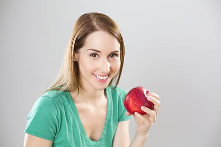 woman holding red apple thumbnail