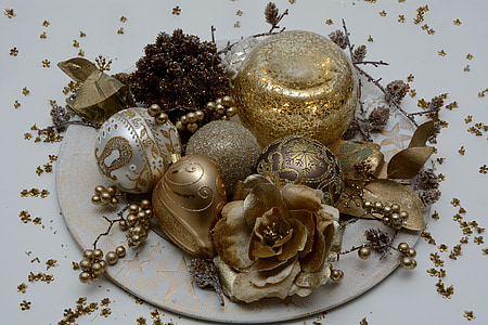 gold Christmas ornaments on white plate thumbnail