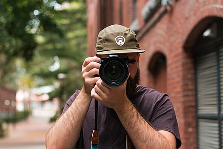 person holding a black DSLR camera thumbnail