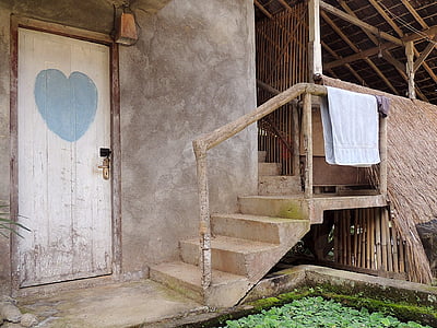 white towel hanging on brown wooden handrail thumbnail