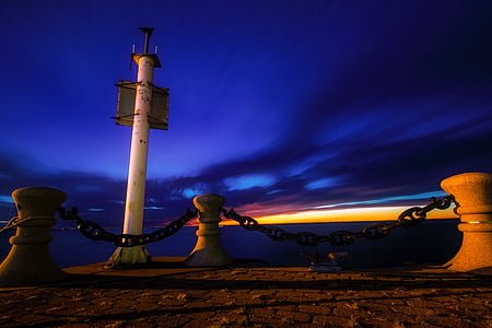 lighthouse under blue sky thumbnail