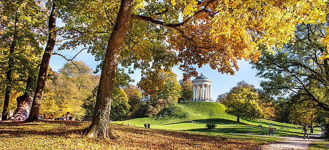 group of people sitting under trees thumbnail