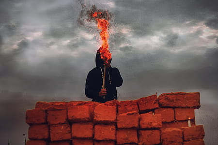 person holding torch under gray clouds during daytime thumbnail
