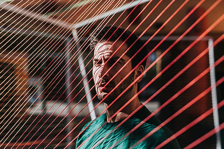 man standing next to red net thumbnail