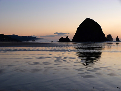 Silhouette of Large Rocks rising out of the Ocean at dusk in Oregon thumbnail