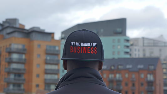 person wearing black let me handle my business cap thumbnail