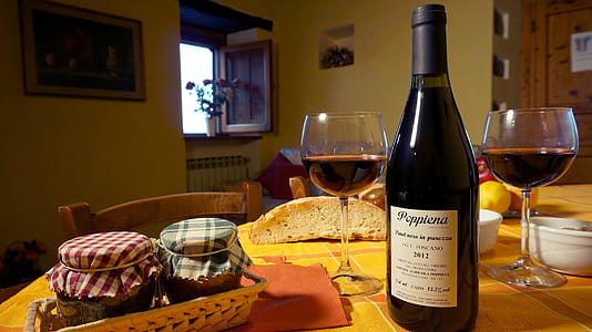 black wine bottle on table thumbnail