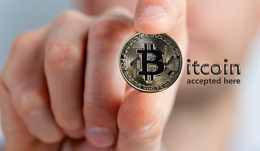 person holding Bitcoin coin thumbnail