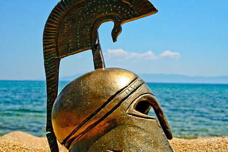 closeup photography vintage helmet near body of water during daytime thumbnail
