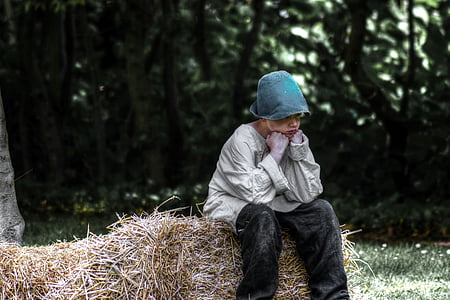 boy sitting on hay feeling sad outdoor thumbnail