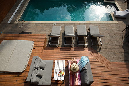 top view photography of loungers near swimming pool thumbnail
