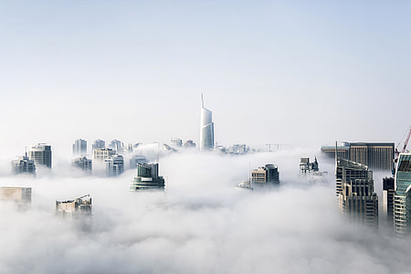 Skyscrapers through the clouds and mist thumbnail