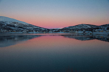 large body of water reflecting mountains thumbnail