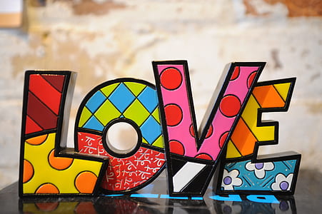 multicolored Love free standing letter on black surface thumbnail