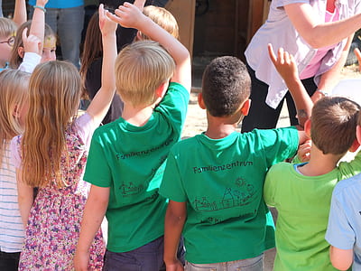 children standing beside person wearing white cardigan thumbnail