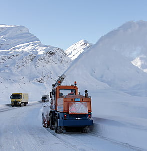 orange and blue tractor on snowy field thumbnail