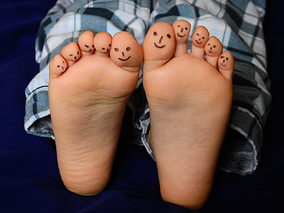 human's feet with smiley drawings thumbnail