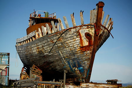 brown and gray ship near building thumbnail