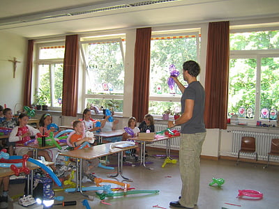 man wearing gray crew-neck T-shirt while holding purple balloon thumbnail